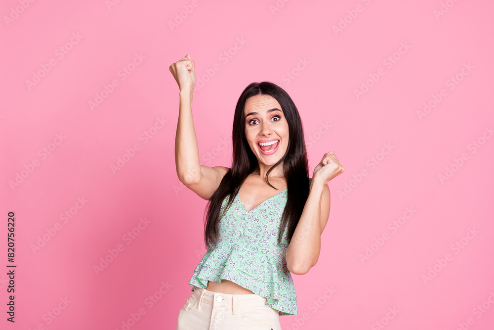 Photo of charming lovely glad woman wear trendy clothes raise hands win success isolated on pink color background Photo of charming lovely glad woman wear trendy clothes raise hands win success isolated on pink color background