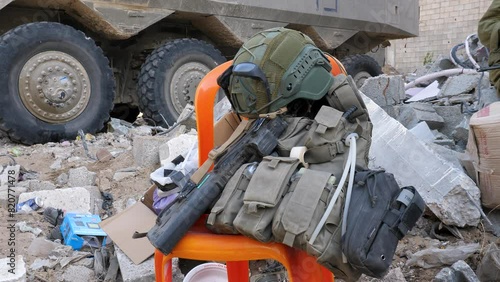 Israeli military reservist utility vest with a rifle and technical helmet during a break, Israel–Hamas war photo