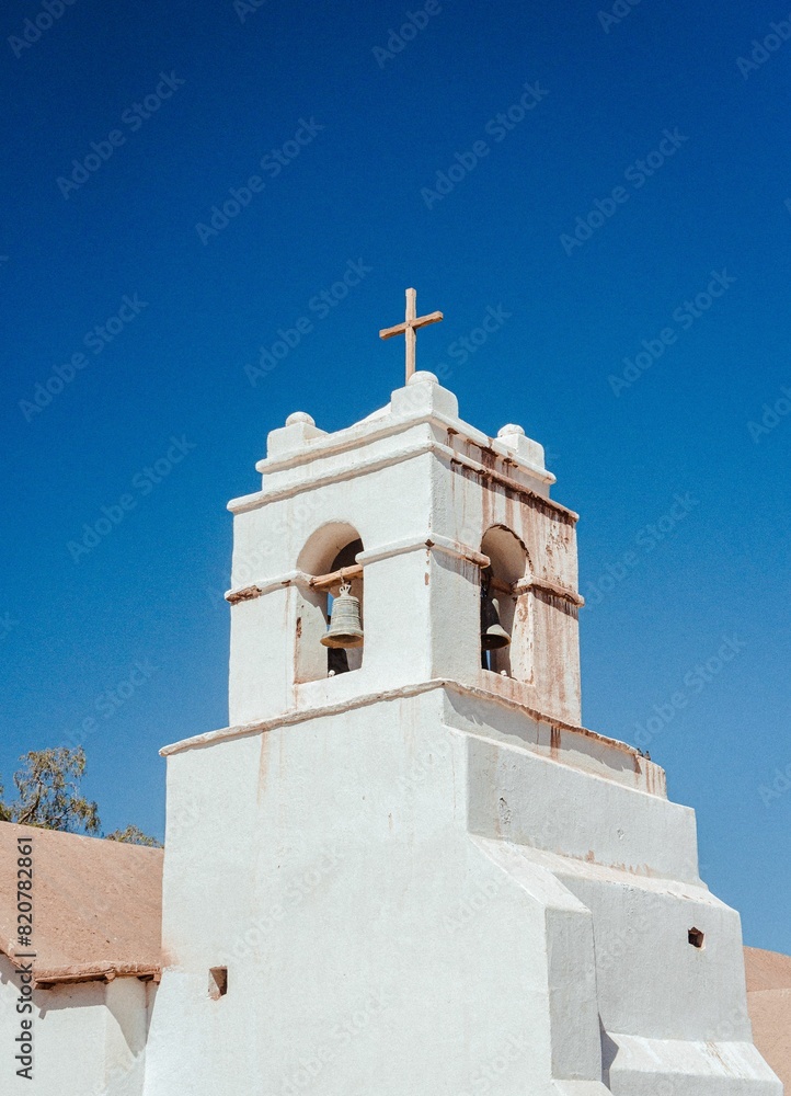 Old, derelict building with a large cross at the top