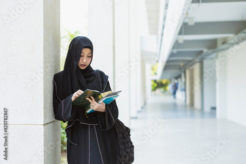 Bilde på lerret Muslim student in university wearing black niqab