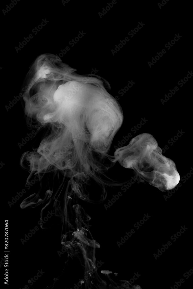 White ink dropped in to water isolated black background. Abstract white color dissolving in water White ink dropped in to water isolated black background. Abstract white color dissolving in water