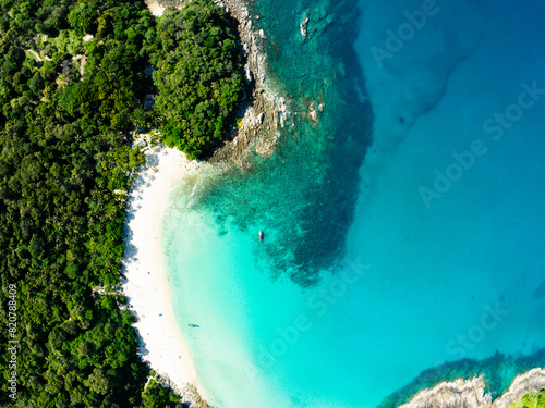 Aerial view Top down seashore background,Waves crashing on rock cliff, Beautiful dark sea surface in sunny day summer background, Amazing seascape top view seacoast at Phuket beach Thailand © panya99