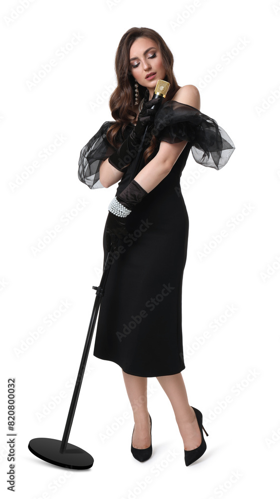 © New Africa - Beautiful young woman in stylish black dress with microphone singing on white background