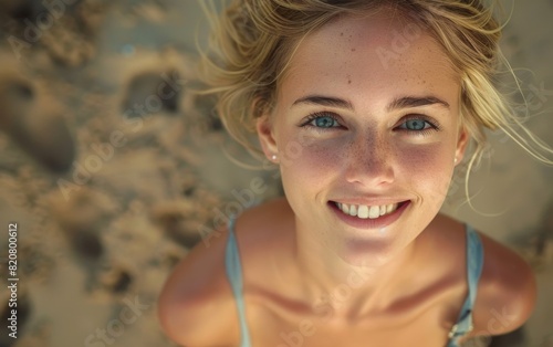 A young woman with striking blue eyes smiles for the camera