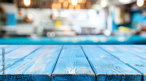 Empty blue wooden table on blurred modern kitchen background © Vlad
