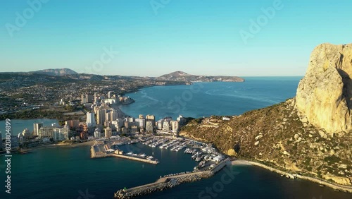 Calp - Spain. View of Peñón de Ifach Natural Park Mountain and Marina of Calpe. Drone backwards, ascending. Panoramic view of all region photo