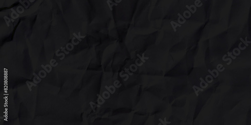 Black crumpled paper texture background. Crumpled black paper abstract shape background with space paper for text photo