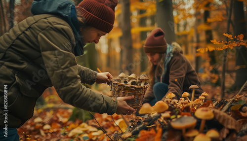 A man and a woman are playing in the leaves