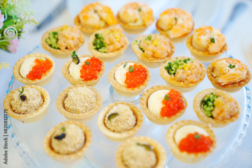 tartlets with pate, red caviar, shrimps and fish. Original snacks for the buffet. catering 
