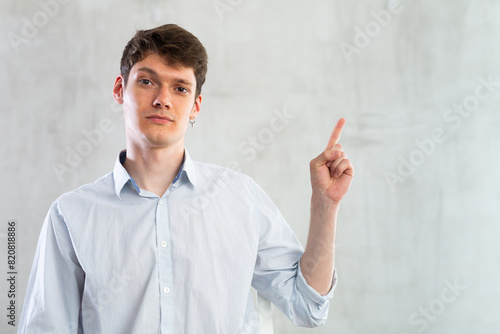 Positive man pointing with his hand at something - advertising concept