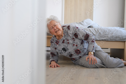 Slika na platnu Elderly woman tripped and fell from bed, injured herself, broke her hip