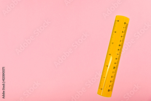 School green ruler on a bright colored background. Stationery. Goods for school. Place for text. Copy space.Top view