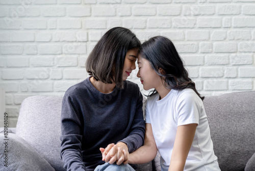 Asian lesbian couple showing their love to each other in a very warm home happily. Showing love, happy moments, LGBT pride