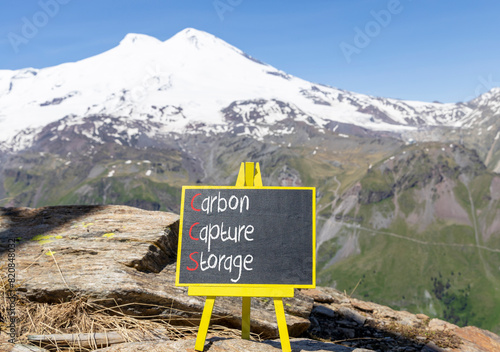 CCS Carbon capture storage symbol. Concept words CCS Carbon capture storage on beautiful yellow blackboard. Beautiful Elbrus background. Business ecological Carbon capture storage concept. Copy space. © Dzmitry