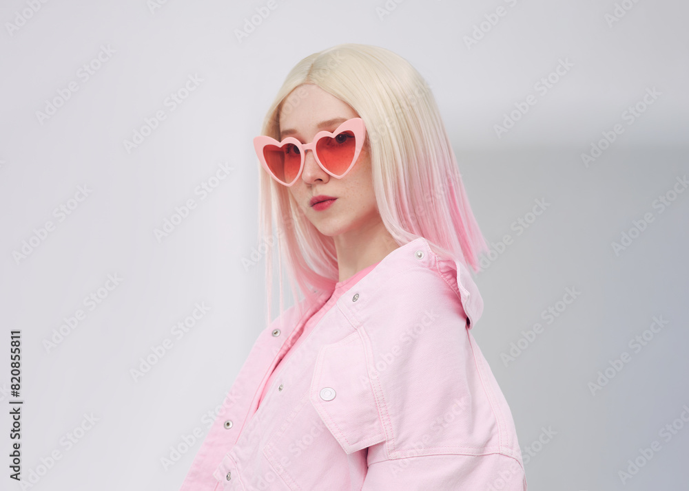 A beautiful woman in a pink vest wearing pink glasses A beautiful woman in a pink vest wearing pink glasses