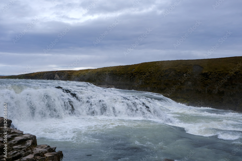 Panoramic view on Gullfoss waterfall on the Hvíta river, a popular tourist attraction and part of the Golden Circle Tourist Route in Southwest Iceland. Golden Waterfall. Panoramic view on Gullfoss waterfall on the Hvíta river, a popular tourist attraction and part of the Golden Circle Tourist Route in Southwest Iceland. Golden Waterfall.