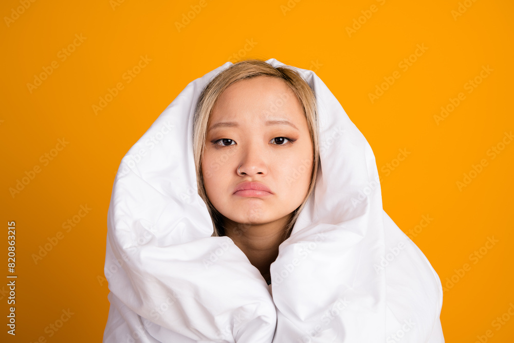 Photo of upset pretty cute woman wrapped warm blanket want sleep isolated on yellow color background Photo of upset pretty cute woman wrapped warm blanket want sleep isolated on yellow color background
