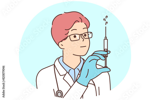 Male doctor with syringe in hands
