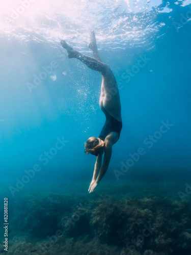 Woman dive in blue sea. Freediving and beautiful slim girl in ocean