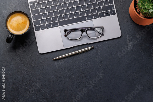 Office desk table with laptop, cup of coffee and supplies © karandaev