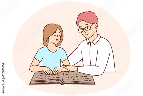 Male tutor teach child reading braille