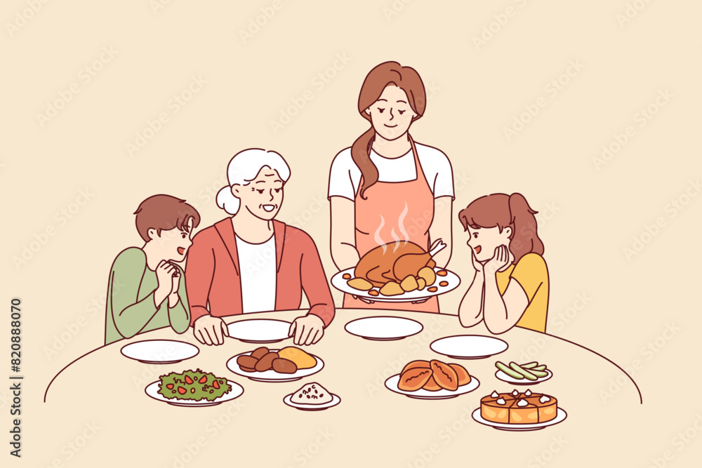 Family celebration of thanksgiving with joint dinner and delicious turkey cooked according to catholic traditions. Caring mother serves poultry meat baked in oven during thanksgiving dinner