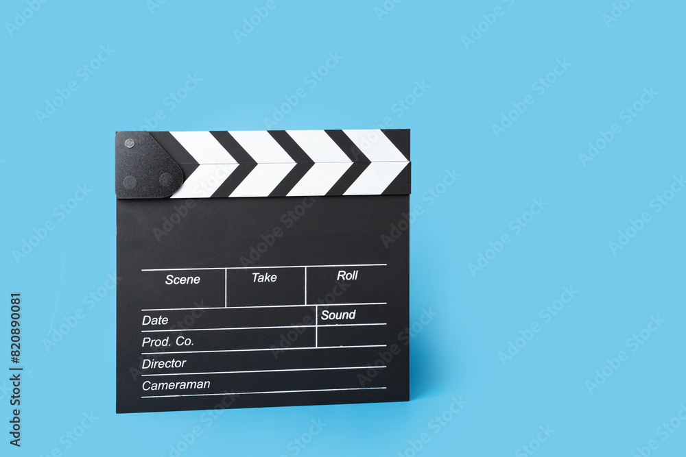 Cinema clapper board on a blue background, copy space, cinematic, camera, action.