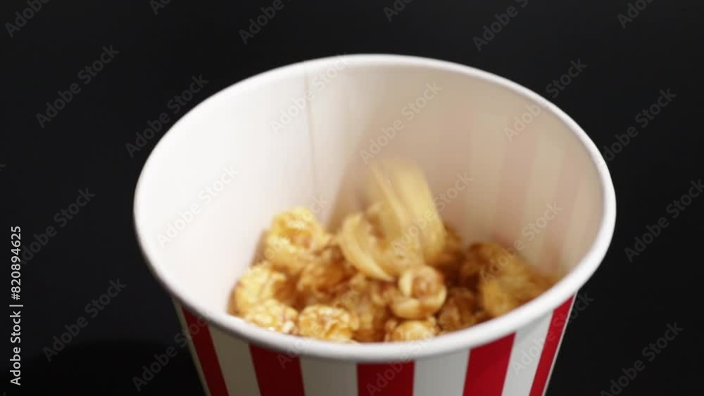 popcorn pouring into a bucket, cinema treat, movie snack, caramel delight, entertainment, sweet corn popcorn pouring into a bucket, cinema treat, movie snack, caramel delight, entertainment, sweet corn
