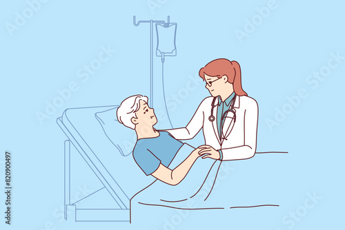 Woman hospice doctor supports dying old man lying in intensive care after unsuccessful support. Girl therapist works in hospice, serving human patient connected to drip with painkillers.