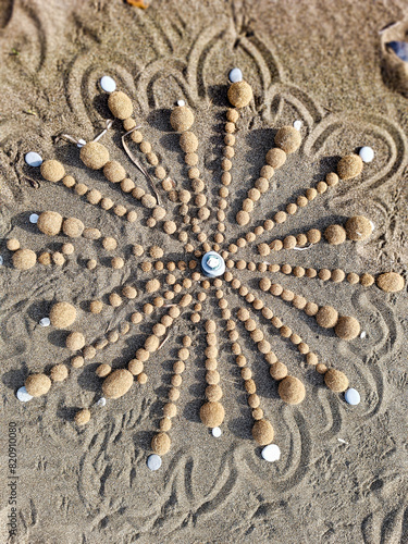 Mandala made with shells and seaweed on the beach of Marina di Castagneto Carducci Tuscany Italy