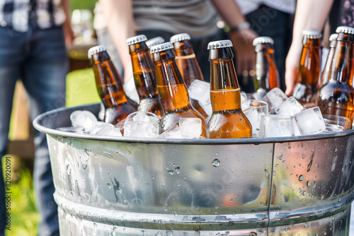 metal bucket tub full of ice and cold beer at a fathers day BBQ picnic, beer, alcohol, fathers day, sunny, summer time