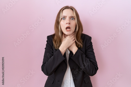 Young caucasian business woman wearing black jacket shouting suffocate because painful strangle. health problem. asphyxiate and suicide concept.