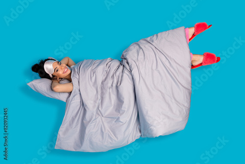 Full body portrait of pretty young woman sleep bed levitate wear pajama isolated on blue color background
