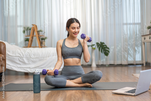 Portrait sport asian beauty body slim woman in sportswear sitting relax and girl practicing yoga and do fitness exercise with laptop computer in bedroom at home.Diet concept.Fitness and healthy