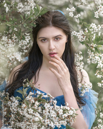 Large portrait of a girl in a blooming garden