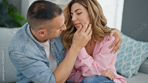 Man and woman couple hugging each other consoling at home