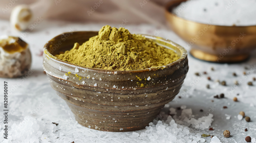 Dry henna powder in bowl and sea salt on light background