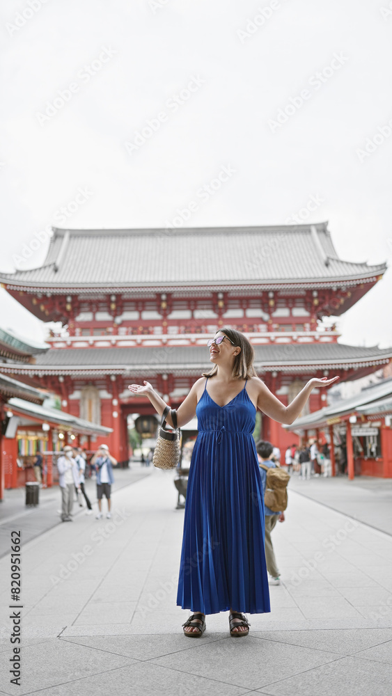 Joyful hispanic woman in glasses, with arms open, looking around senso-ji temple, tokyo with a beautiful smile embracing the carefree lifestyle. Joyful hispanic woman in glasses, with arms open, looking around senso-ji temple, tokyo with a beautiful smile embracing the carefree lifestyle.