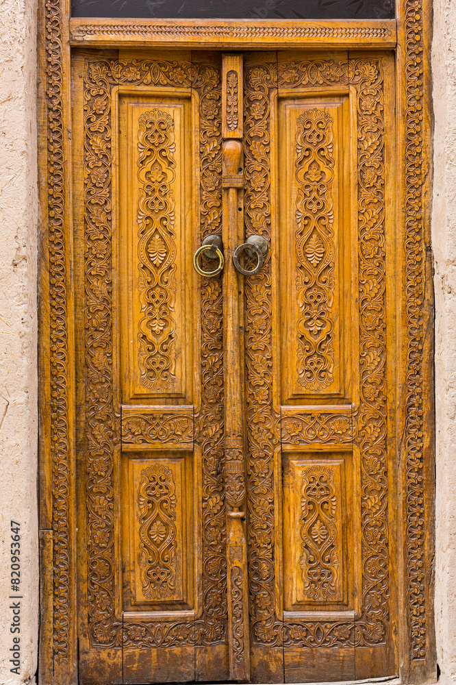 Wooden door of old houses in Itchan Kala, Khiva
