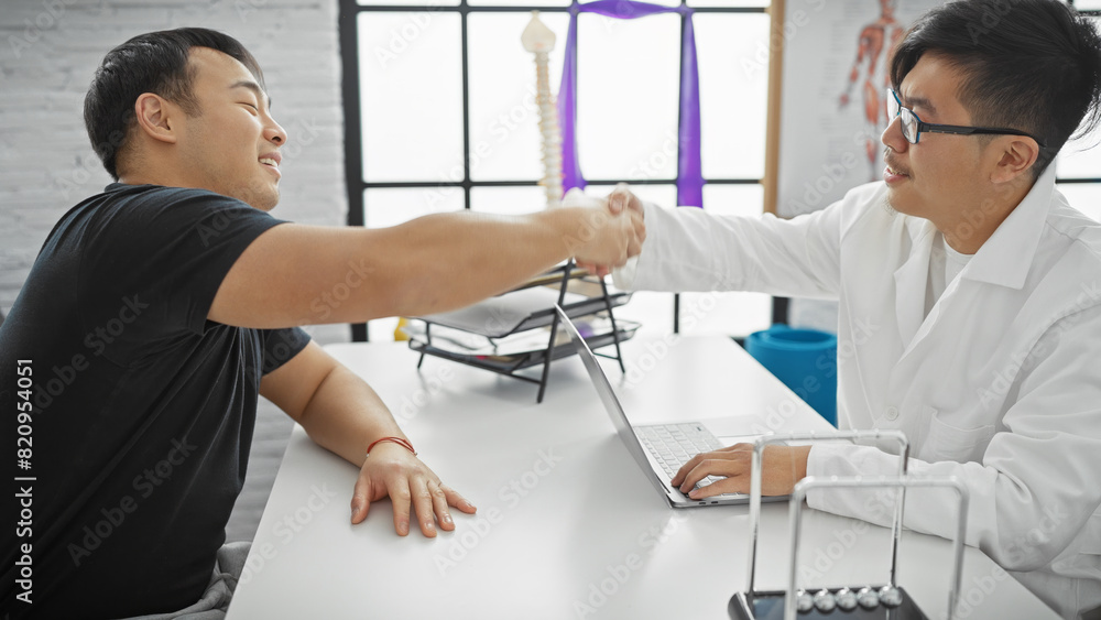 Two men handshake at a medical consultation, portraying a patient and doctor in a clinic's interior. Two men handshake at a medical consultation, portraying a patient and doctor in a clinic's interior.
