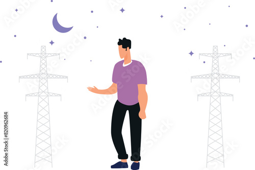 The boy stands by the towers at night.