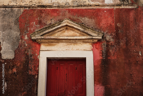 traditional greek architecture, wooden entrance door, old painted walls, rustic texture, abandoned property need maintenance © Ela