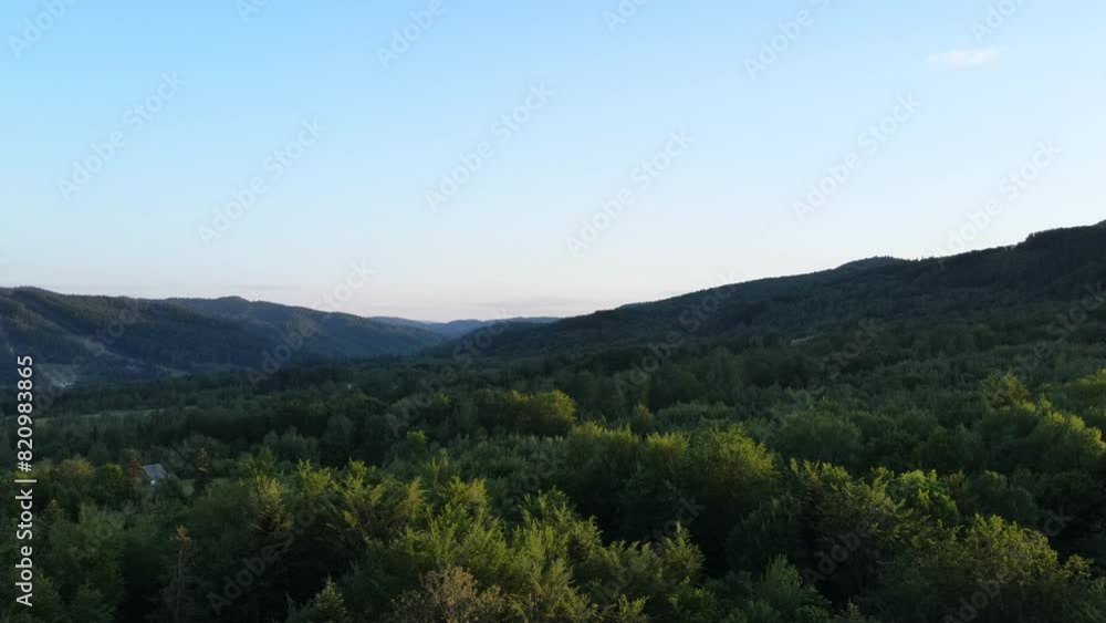 Aerial drone view of beautiful summer mountains, houses, road during calm sunset. Nature inspiration. Rural area on background summer landscape. Destination for tourism and wanderlust Aerial drone view of beautiful summer mountains, houses, road during calm sunset. Nature inspiration. Rural area on background summer landscape. Destination for tourism and wanderlust