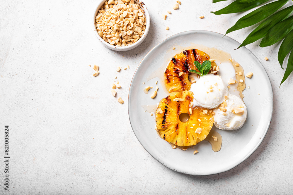 Grilled pineapples with icecream, tropical dessert Grilled pineapples with icecream, tropical dessert
