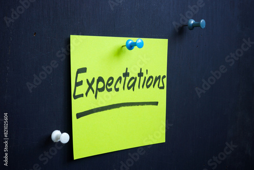 A piece of paper with an inscription expectations is pinned to the board.