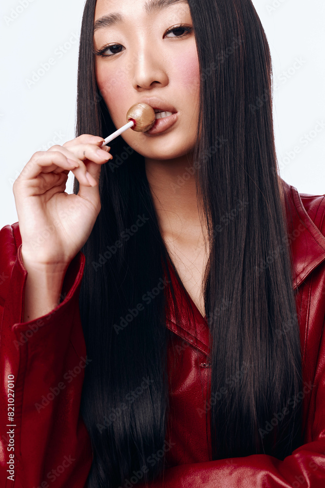 Woman with long black hair and red jacket holding toothbrush in mouth, ready for morning routine Woman with long black hair and red jacket holding toothbrush in mouth, ready for morning routine