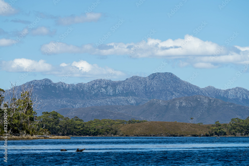 Beautiful Rocky Mountain over a lake in a beautiful park. Wilderness landscape with no people. Stunning bush and forest by the sea and ocean. Beautiful Rocky Mountain over a lake in a beautiful park. Wilderness landscape with no people. Stunning bush and forest by the sea and ocean.