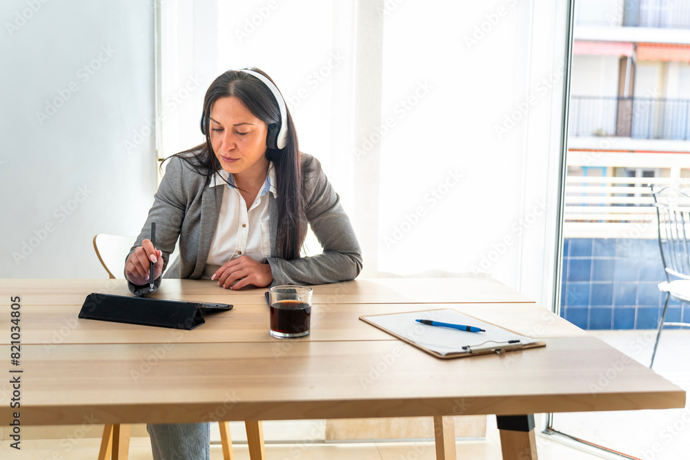Middle aged Romanian businesswoman teleworking from home Middle aged Romanian businesswoman teleworking from home
