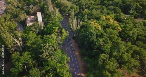 Odessa aerial view following a cyclist walking on a road around a tree