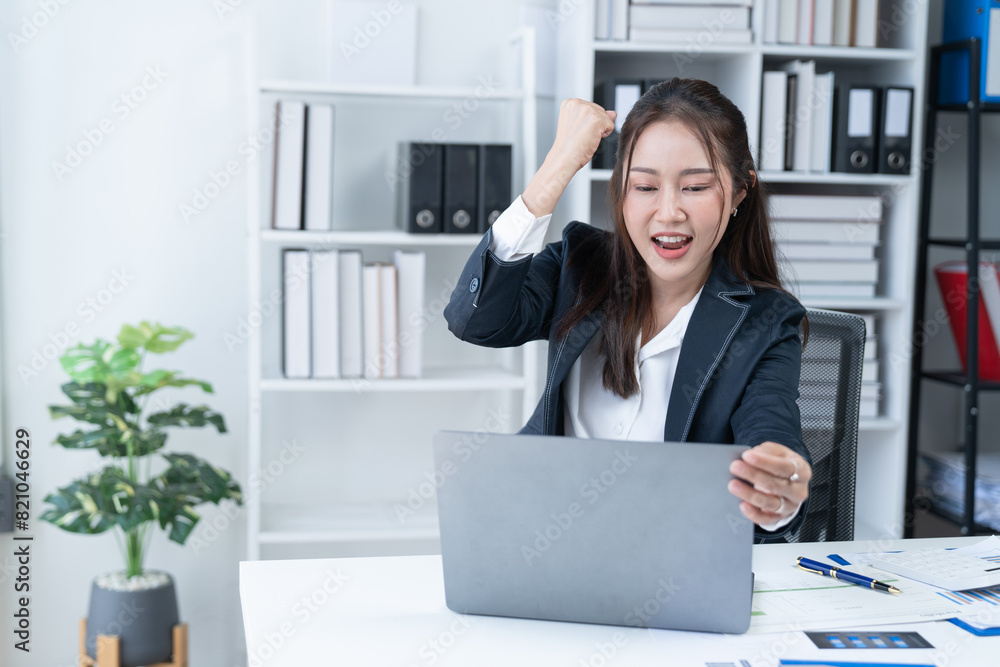 The Asian female business professional displayed a cheerful expression in her office.